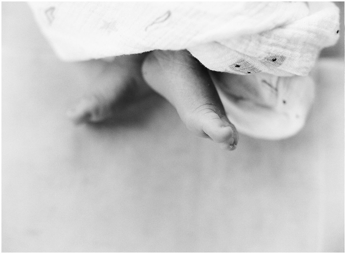 baby toes swaddled in a black and white photo in newborn photography session
