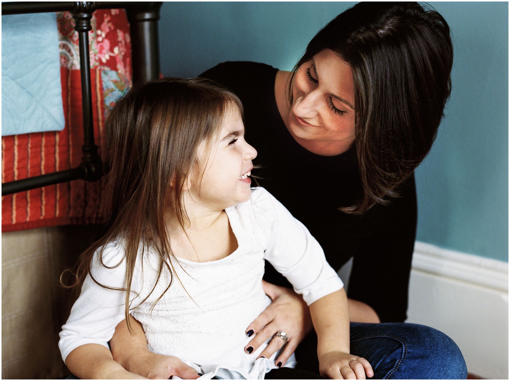mother and daughter sharing a happy moment at home in motherhood and family photography