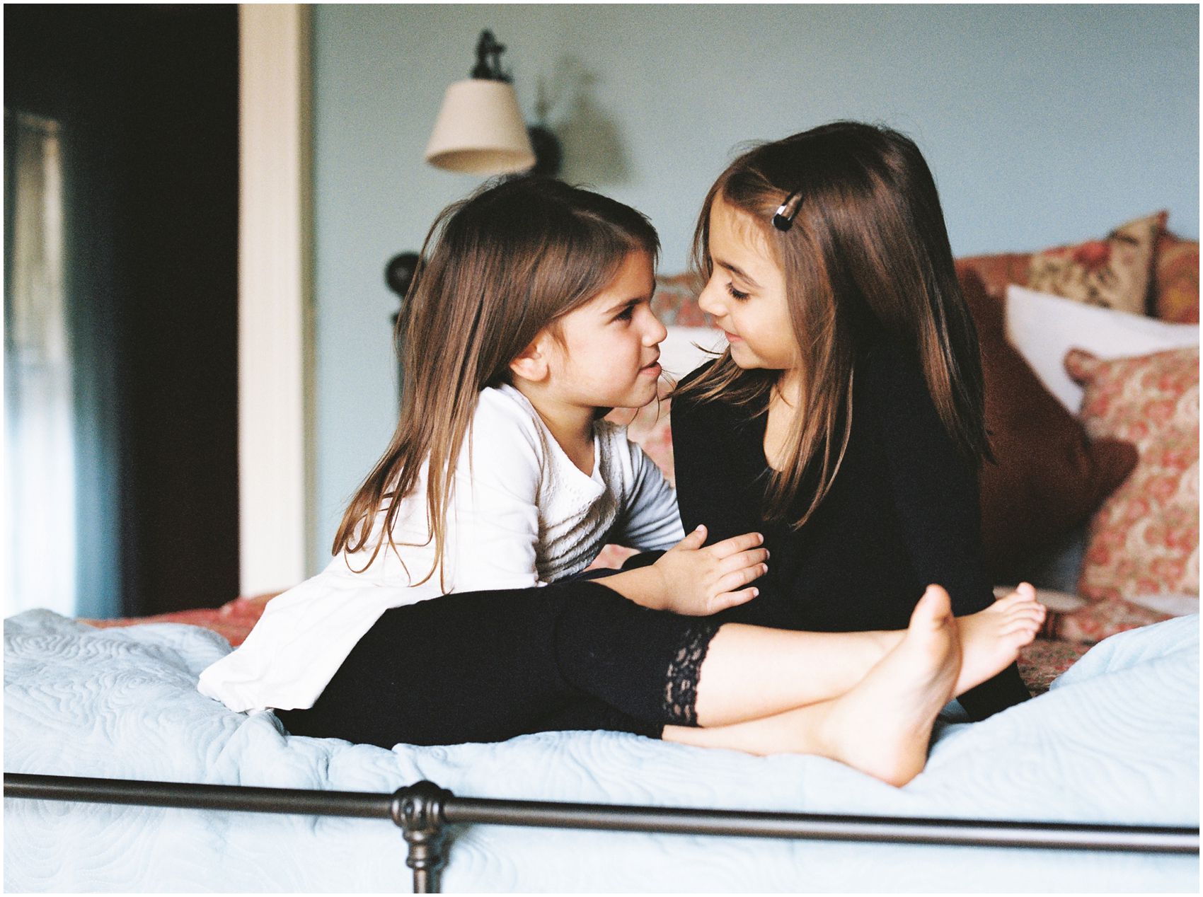 Family Photographer Miriam Dubinsky captures a loving bond between two sisters at home of Bergen County, NJ