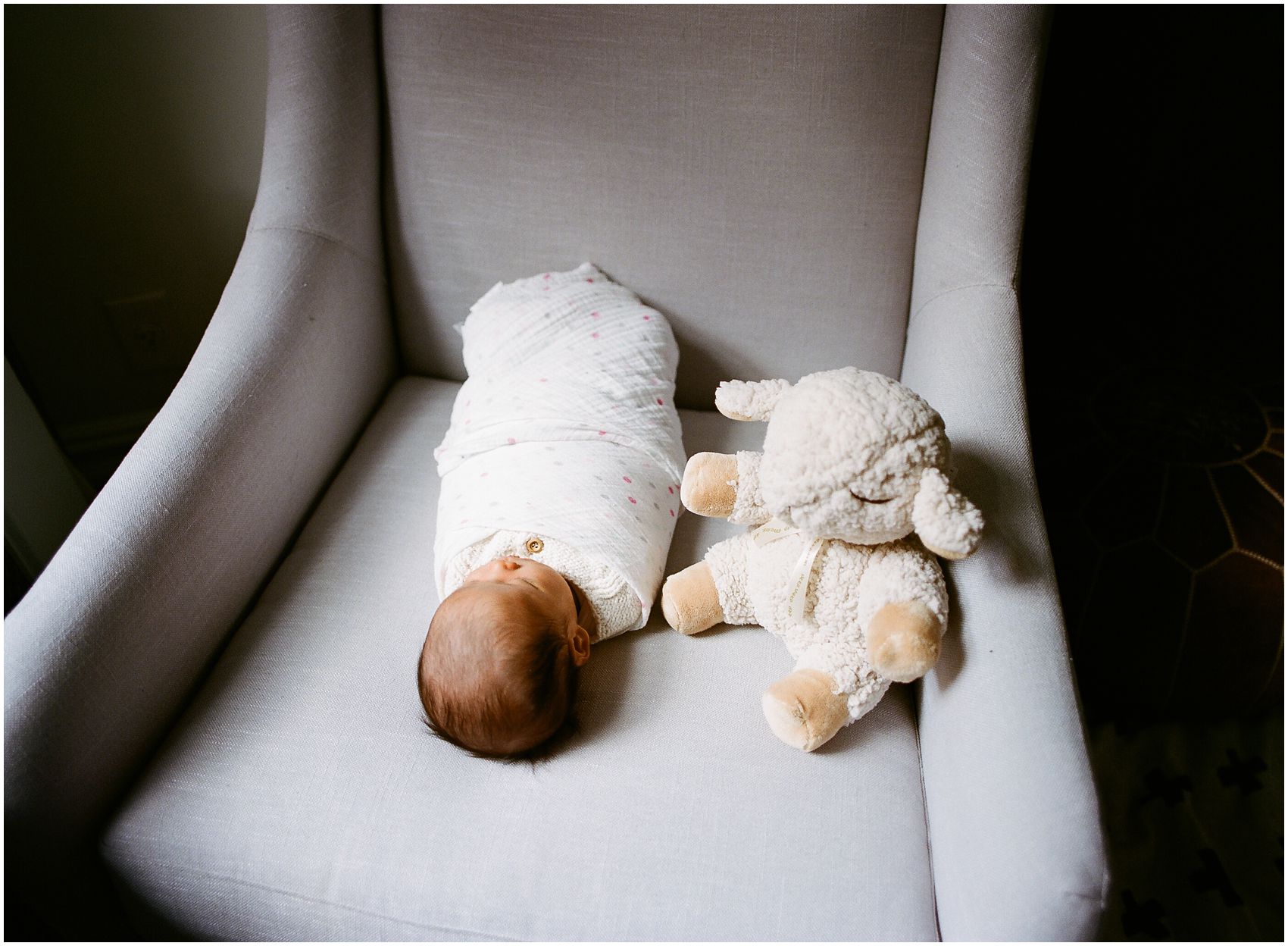 Newborn photos in NYC with a new baby girl sleeping with a toy animal