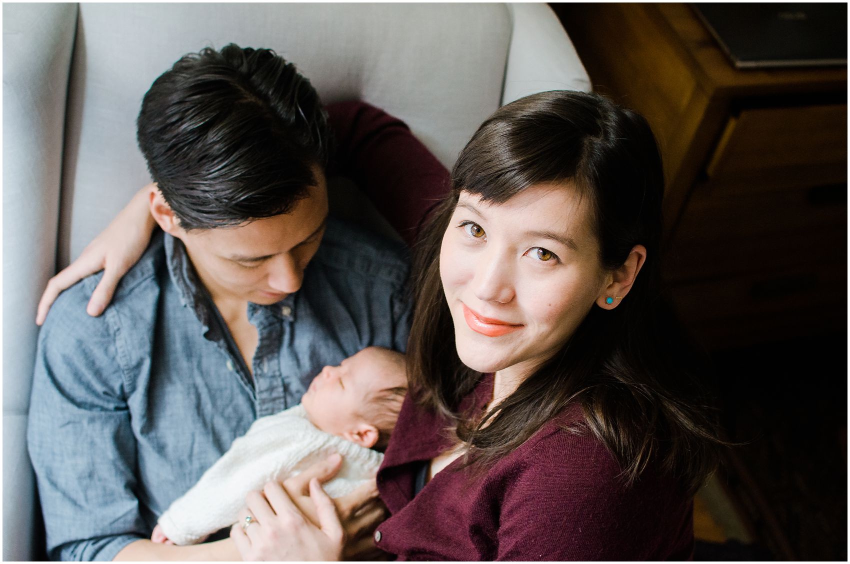newborn photography at home with mom and dad holding the baby