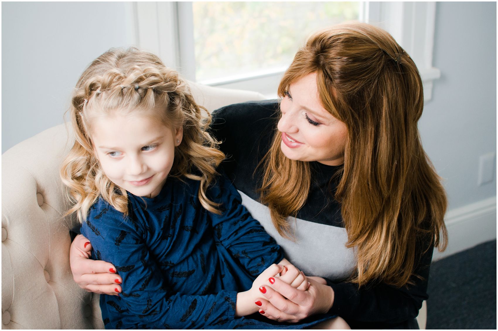 happy mom sitting with daughter