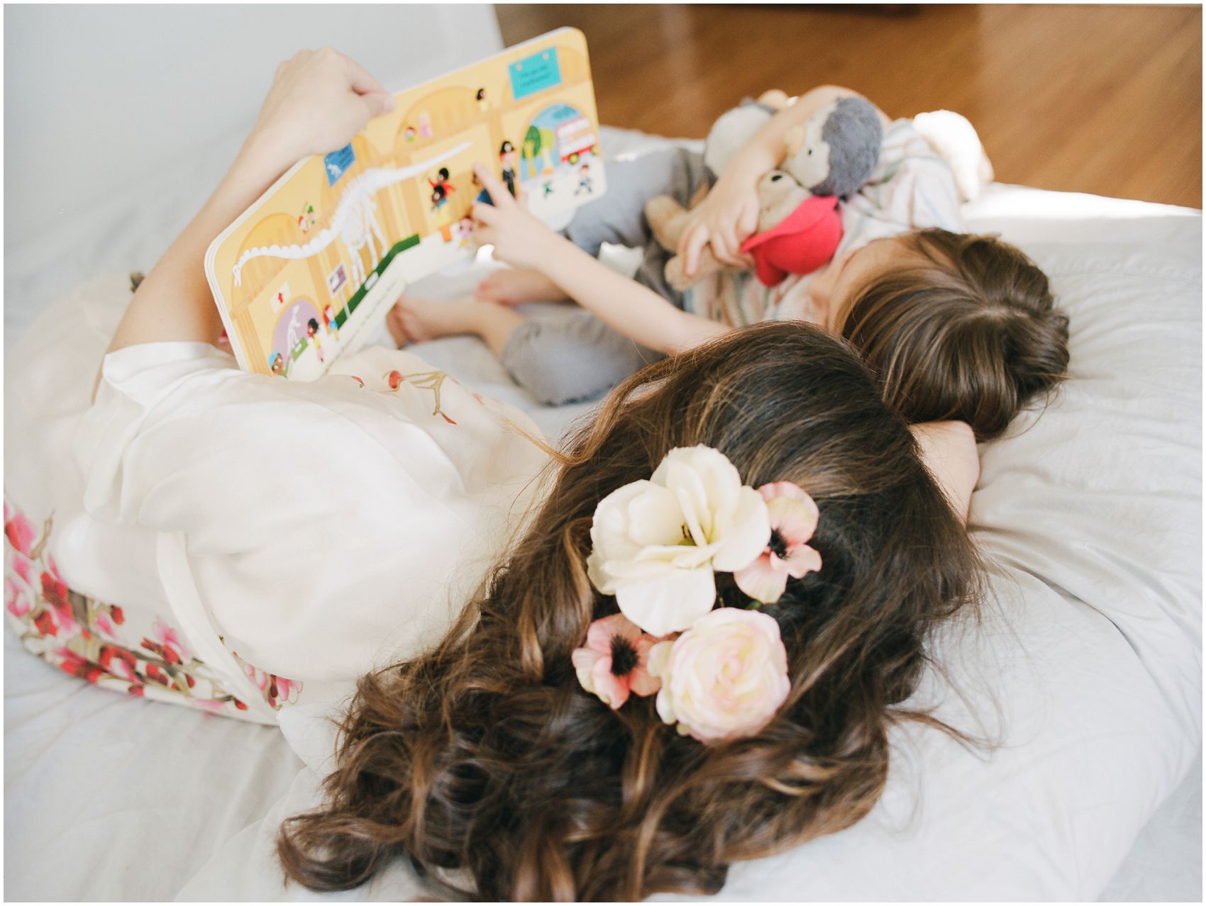 beautiful hair flowers for mom reading a book with her son in bed