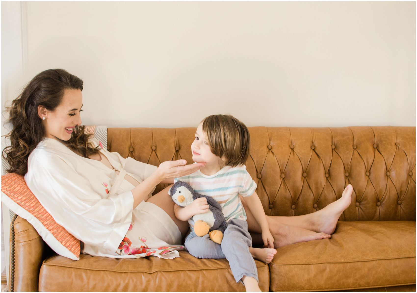 mom and little boy sitting on the couch of their Montclair NJ home