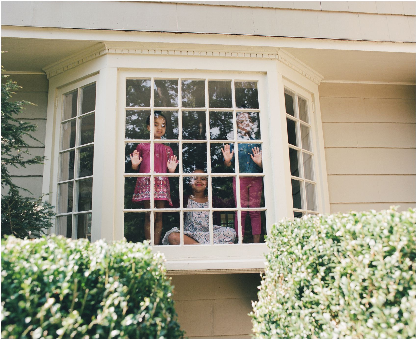3 sisters looking out the window of their Verona NJ home