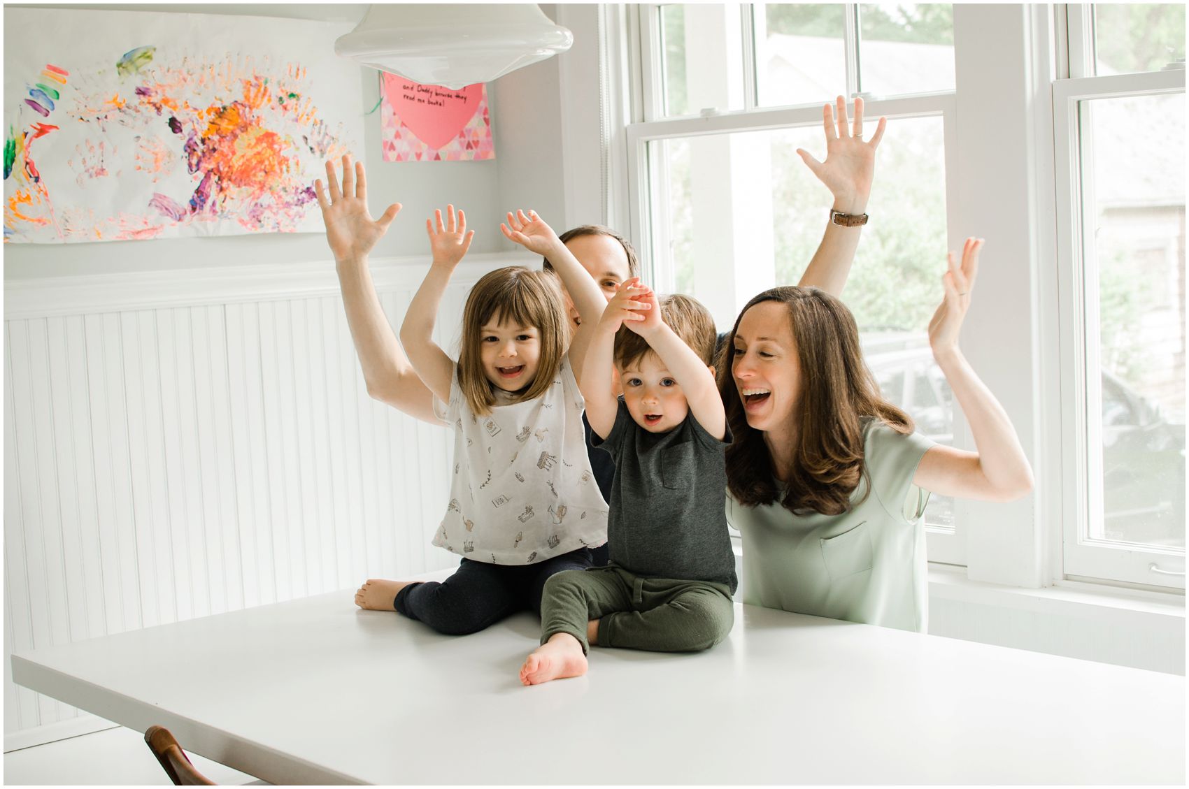 mom dad and two kids wave their hands hooray in Manhattan
