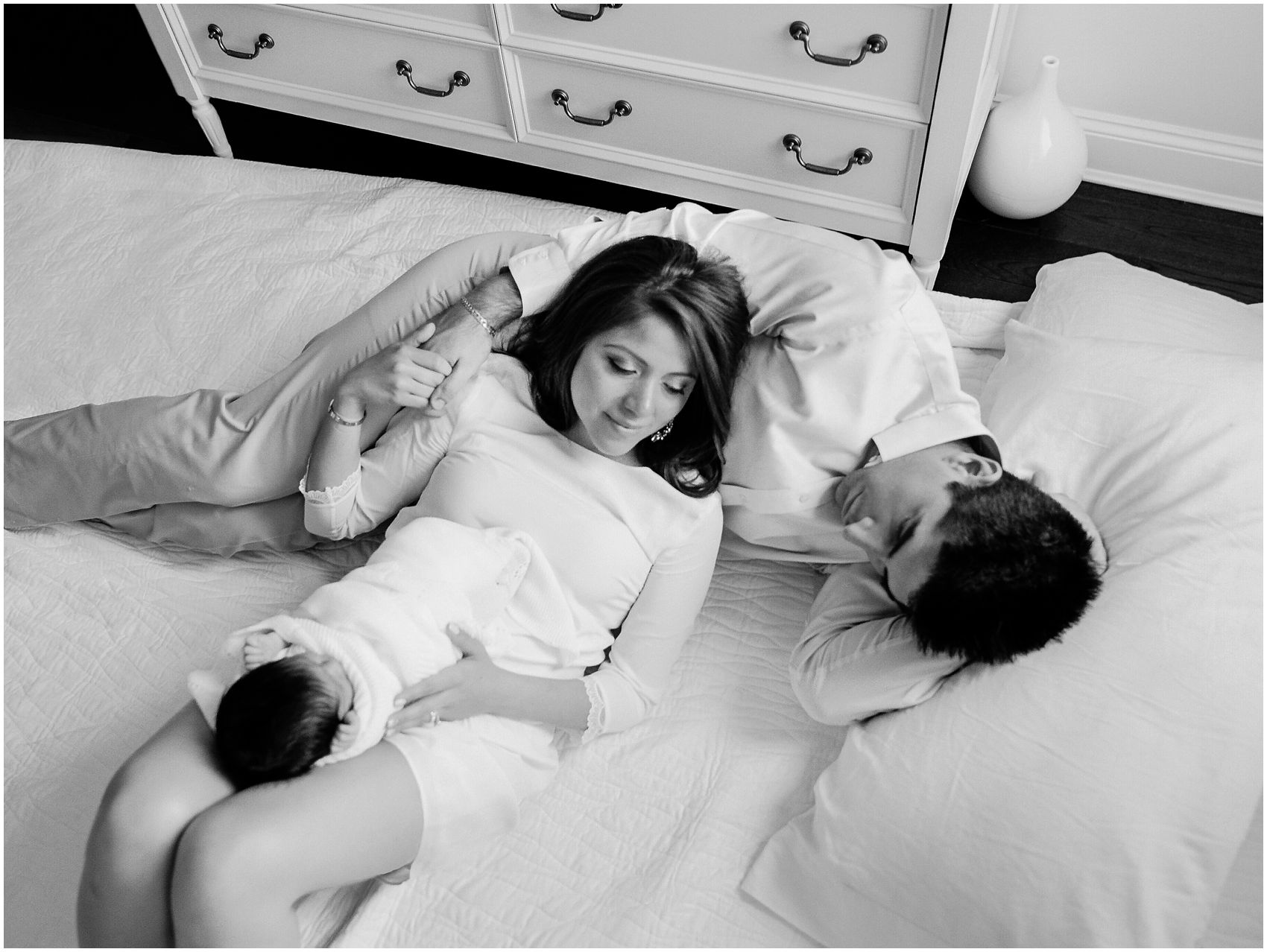 parents and baby relaxing on the makeshift bed on the floor for the indoor portraits in tight space