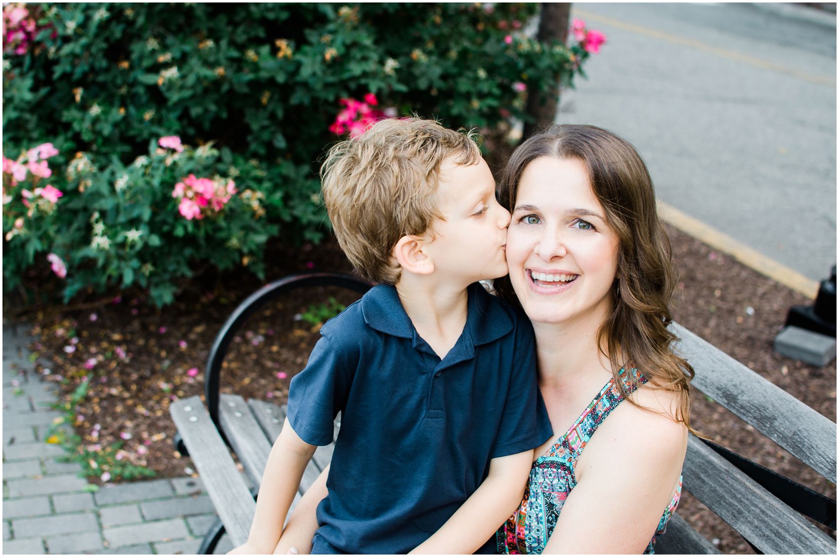 a son gives his mama a sweet kiss in family fun photos by Hoboken Waterfront.