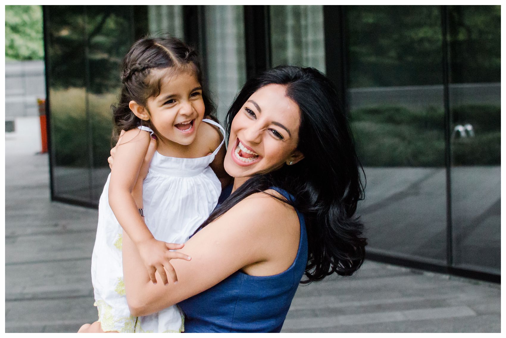 mom laughing with her daughter in family mini session in New York during the portraits by the best Family Photographer Miriam Dubinsky