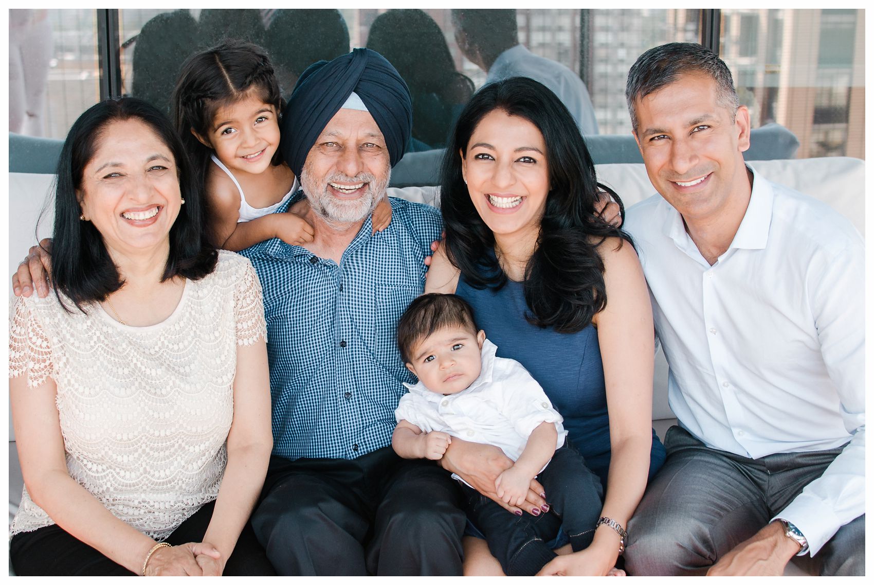 parents, grandparents and children sit for a natural light family photo but NYC best Family Photographer Miriam Dubinsky