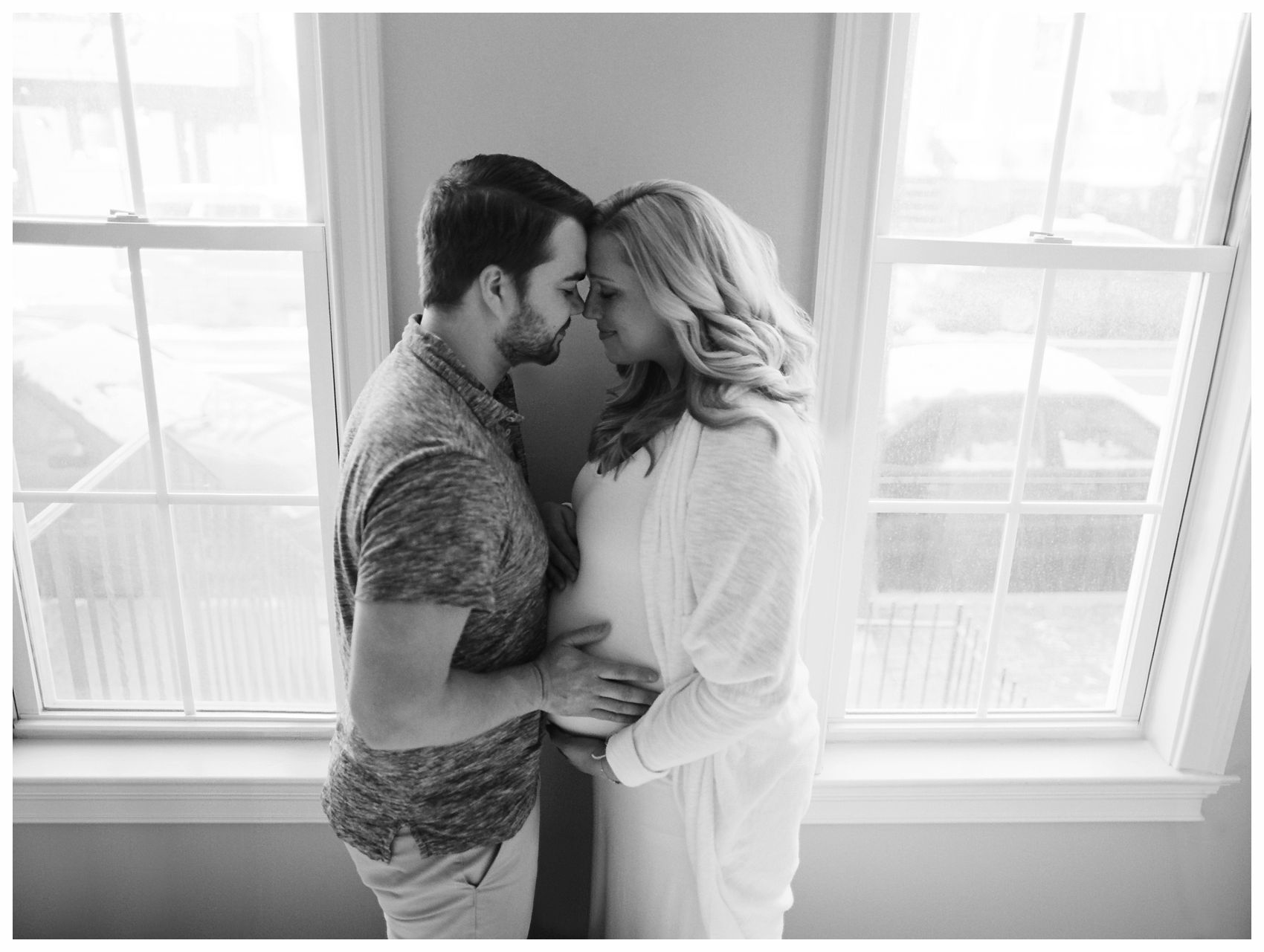 Maternity Photography NYC with pregnant couple snuggling by the window of their Hoboken NJ home