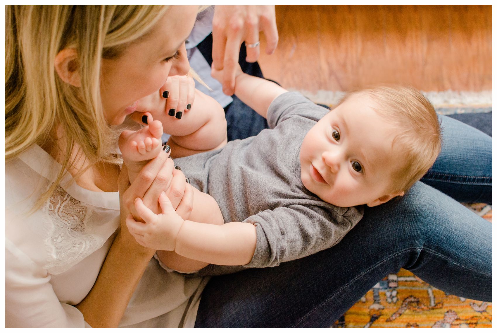 mommy is playing with her baby boy on her lap in her Hoboken NJ condo